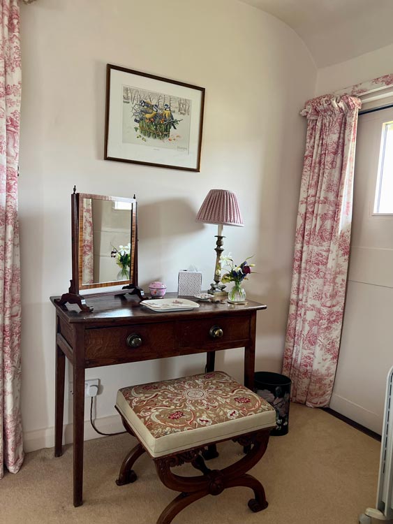 Bed in bedroom at Well Farm Cotswolds